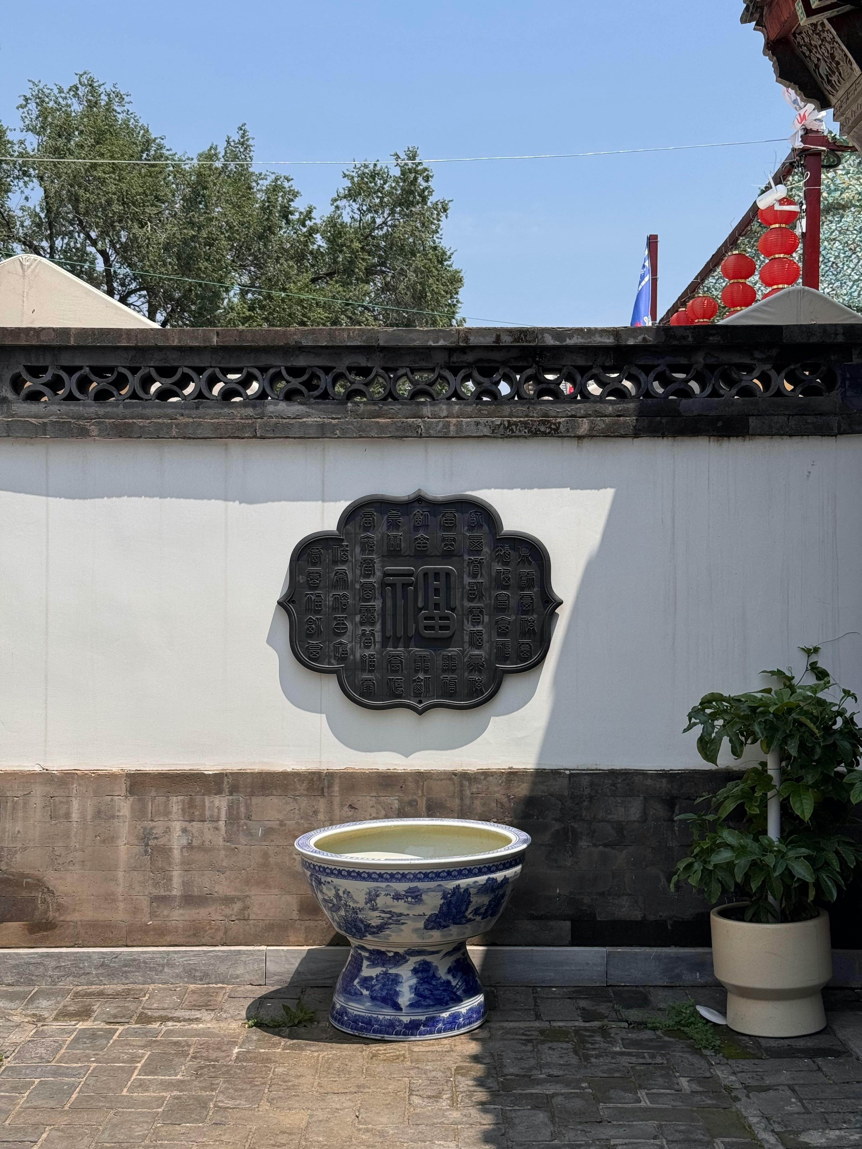 Master potter shaping a clay pot on a traditional kick wheel in a Jingdezhen ceramics studio